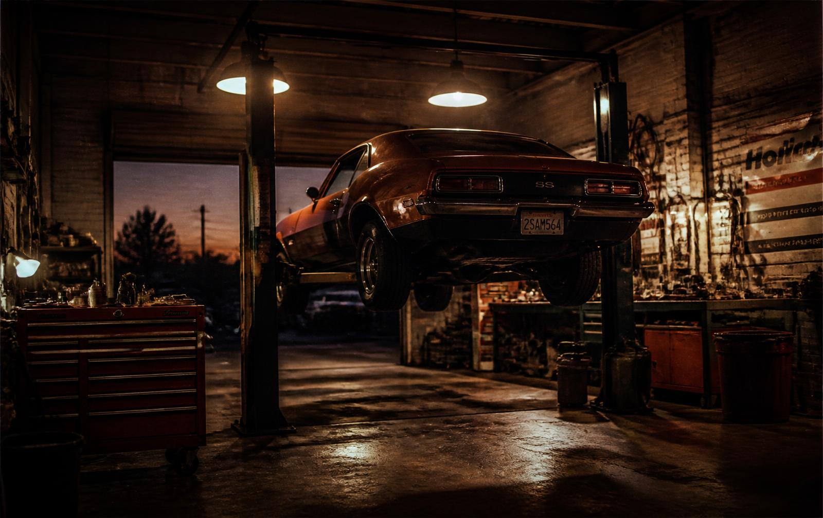 Classic car raised on a lift inside the GDL Auto service bay